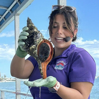A conch being shown on a boat in Sarasota Bay